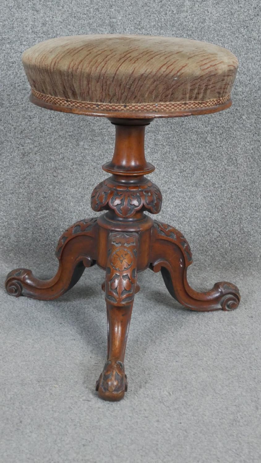 A Victorian carved walnut revolving adjustable piano stool on tripod cabriole base. h50 d45 - Image 3 of 3