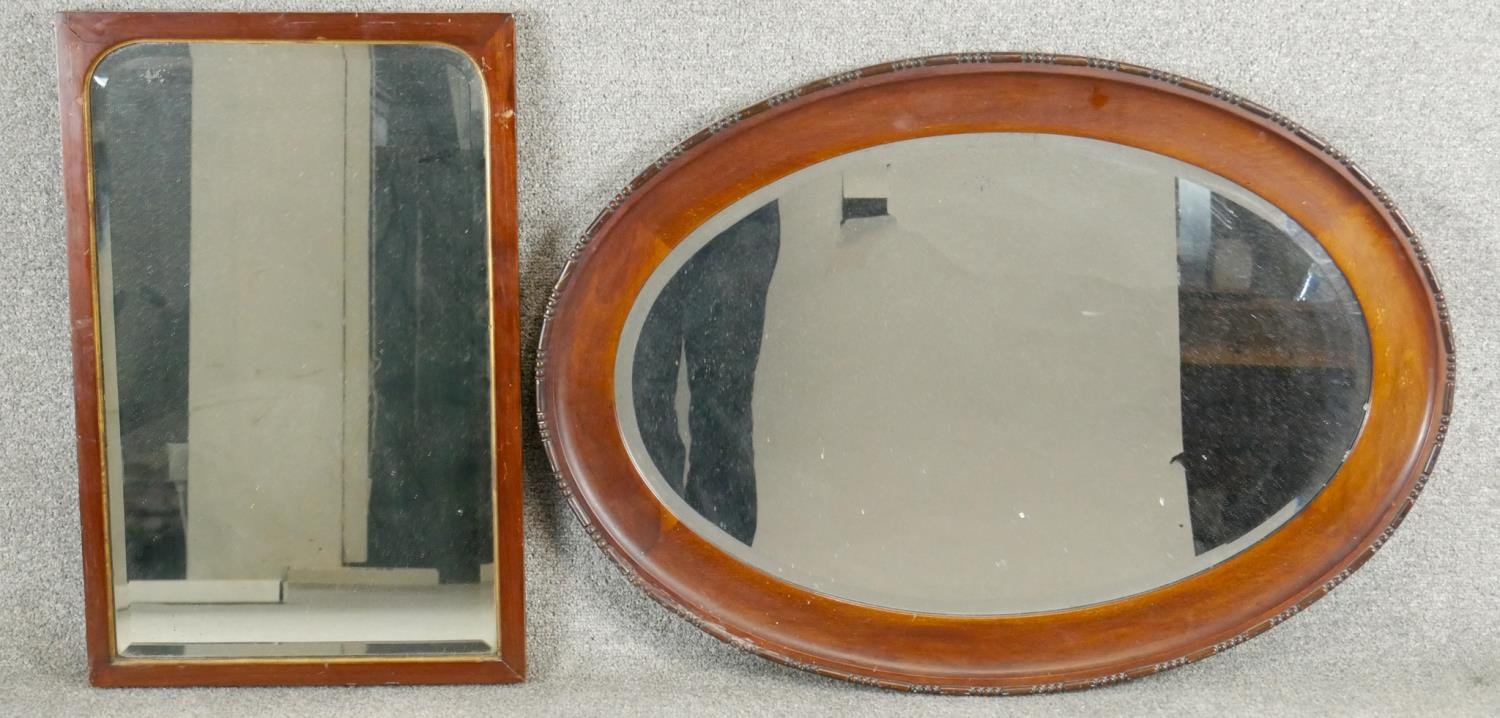 A 19th century mirror in mahogany frame with gilt slip and a vintage oval mirror.