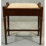 A C.1900 mahogany music stool with lift up seat and sheet music compartment. H.55cm