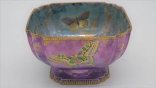 An Aynsley fairyland pink and blue lustre pedestal bowl hand painted with gilded butterflies. Makers