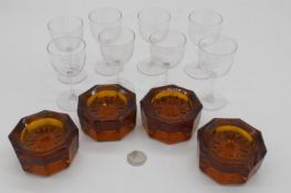 A set of eight Victorian blown glass stemmed sherry glasses along with a set of four amber glass