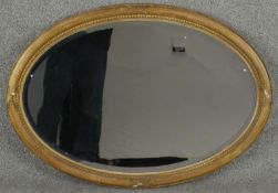 A 19th century gilt wood and gesso wall mirror in reeded and gadrooned frame. H.62 W.86cm