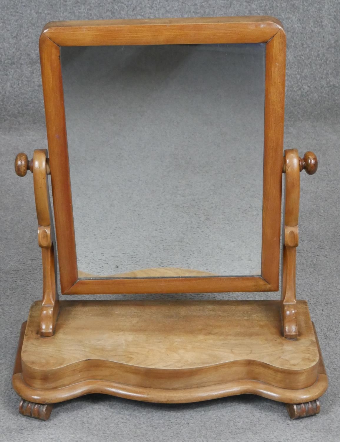 A Victorian walnut swing frame toilet mirror. H.57cm