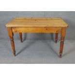 A Victorian pine kitchen table with end cutlery drawer on turned tapering supports. H74 W120 D80cm