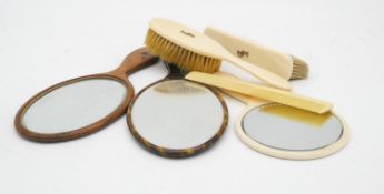 A collection of six Victorian brushes and mirrors. Three with ivory backs and white metal applied
