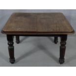 A Victorian mahogany extending dining table on tapering fluted supports. H.64 L.106 W.104cm (no