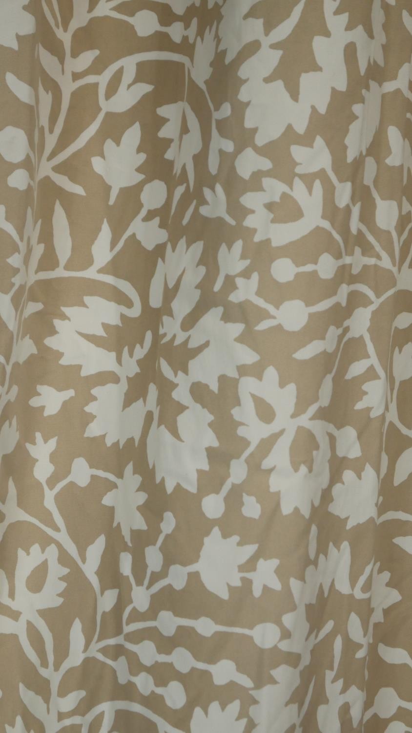 A pair of taupe ground stylised floral and foliate design lined curtains. With a pair of tie