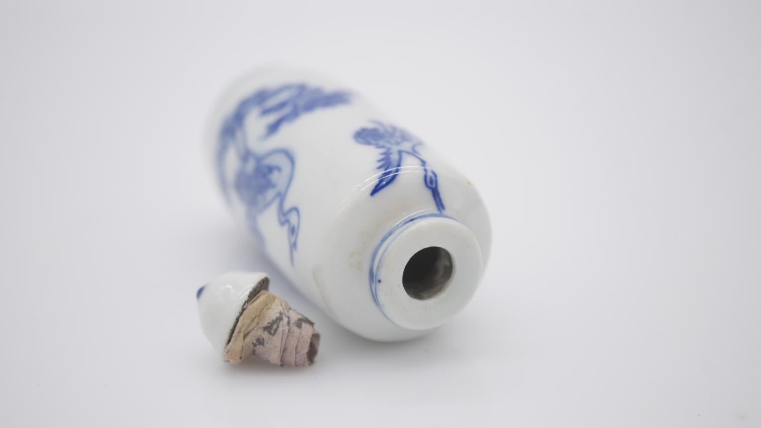Two Chinese hand painted blue and white porcelain snuff bottles with blue glazed stoppers. One - Image 7 of 8