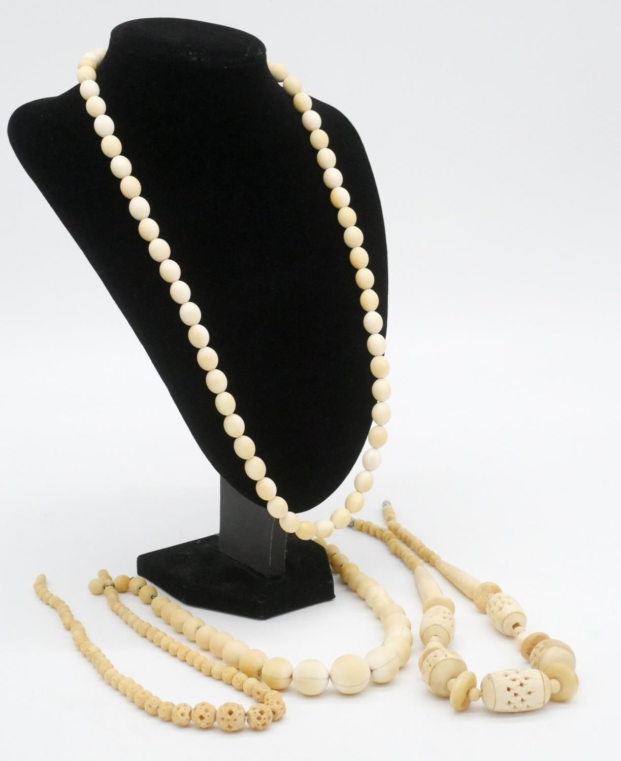 Two Victorian carved graduated ivory bead necklaces along with two Indian pierced bone bead