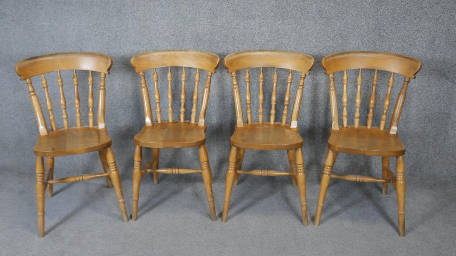 A set of four late 19th century bar back kitchen chairs with elm seats.