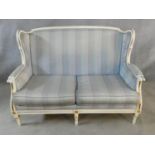 A Louis XVI style gilt and white painted two seater sofa in pale damask upholstery. H.93 L.136 D.
