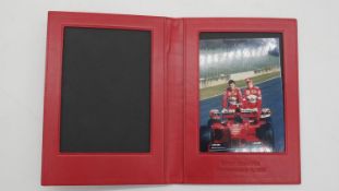 A boxed red leather Ferrari presentation wallet with Michael Schumacher photo. Wallet embossed