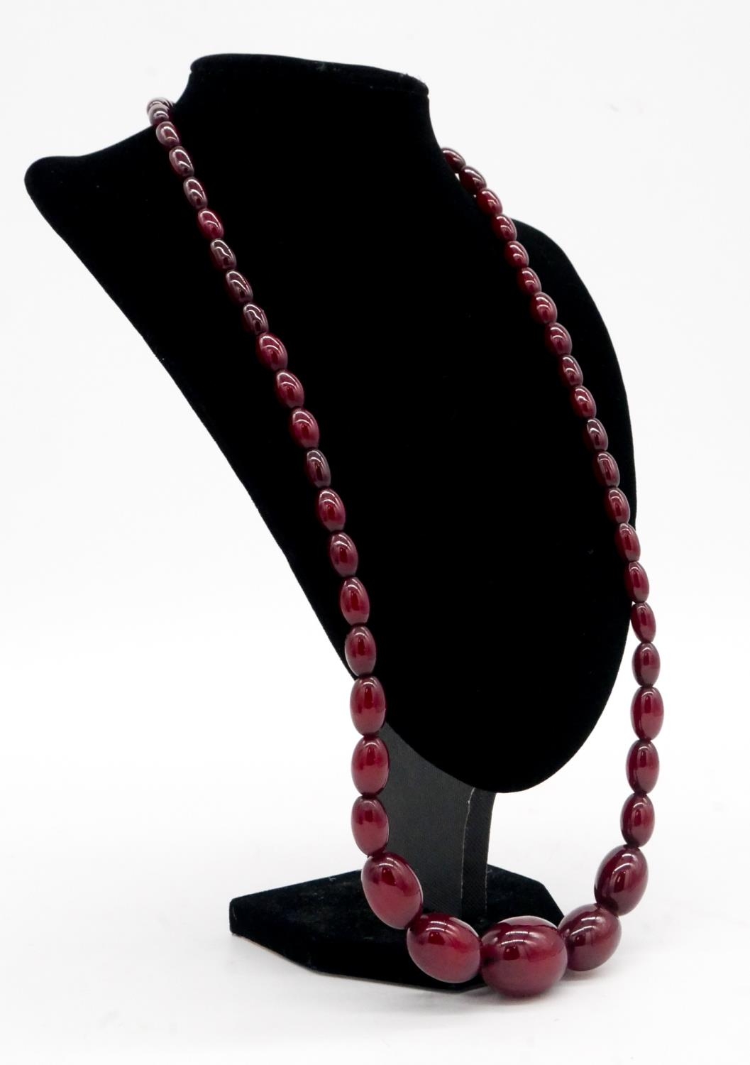 A vintage 30 inch cherry amber bakelite graduated necklace with silver lobster clasp, stamped 925. - Image 2 of 4
