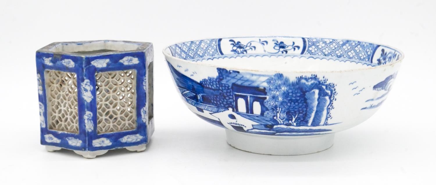 An 18th century blue and white porcelain bowl with unglazed foot and painted Oriental scene. Along