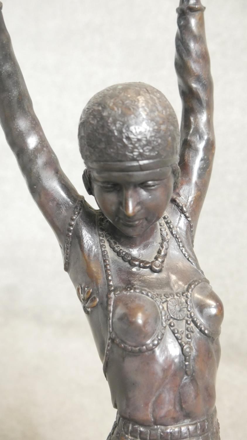 An Art Deco style spelter sculpture of a female dancer in period clothing with headdress, on a - Image 3 of 5