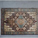 A Hamadan rug with flowerhead decoration within foliate spandrels and multiple borders,