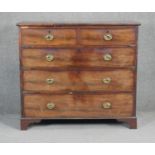 A Georgian mahogany chest with brass oval plate handles on shaped bracket feet. H98 W110 D48