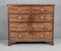 A Georgian mahogany chest with brass oval plate handles on shaped bracket feet. H98 W110 D48