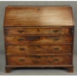 A Georgian mahogany bureau the fall front revealing inlaid and fitted interior above four long