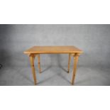 An oak and pine centre table with carved animal masks to each support. H.70cm