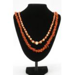 Two coral necklaces. One comprising of graduated sections of red branch coral and polished round