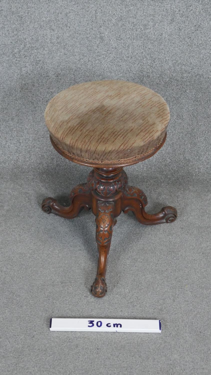 A Victorian carved walnut revolving adjustable piano stool on tripod cabriole base. h50 d45 - Image 2 of 3