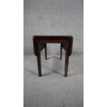 A 19th century mahogany drop flap table on square tapering supports. H.46 W.75 D.61cm