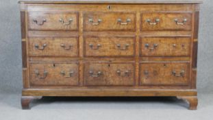 A George lll Lancashire mule chest with lift up lid and two rows of dummy drawers above three base