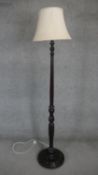 A mid century mahogany standard lamp with flutted and turned column on platform base. H180cm