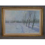 A gilt framed oil on canvas, snowy winter country track, signed Antonelli. H.76 W.105cm