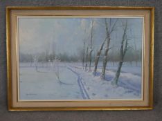 A gilt framed oil on canvas, snowy winter country track, signed Antonelli. H.76 W.105cm