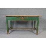 A 19th century pine planked top dining table on distressed painted base fitted with frieze drawer.
