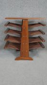 An Eastern teak coffee table with brass inlay and magazine rack to the base. H.60 W.50 D.40cm