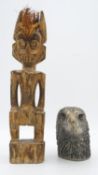 A carved wooden tribal figure along with a cast silver plated eagles head, a double dragon stamp
