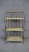 A contemporary metal framed baker's rack with woven shelves. H.96 W.50 D.25cm