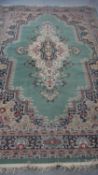 A Persian style woollen carpet with floral spandrels and multiple borders. 300x200cm