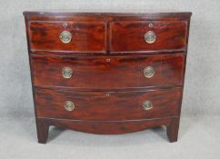 A Georgian mahogany bow fronted chest of drawers with brass plate handles on shaped bracket feet.