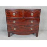 A Georgian mahogany bow fronted chest of drawers with brass plate handles on shaped bracket feet.