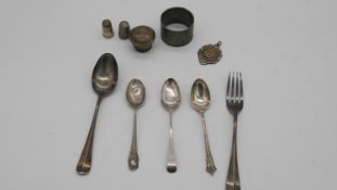 A collection of silver. Including silver cutlery, a silver napkin ring, thimbles and other silver