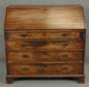 A Georgian mahogany bureau the fall front revealing inlaid and fitted interior above four long