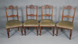 A set of four late 19th century carved walnut dining chairs.