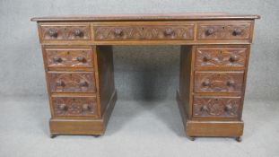 A Victorian three section carved oak pedestal desk with original inset leather top. H.74 W.120 D.