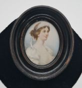 A 19th century ebonised framed and glazed portrait miniature on ivory of a lady in white silk