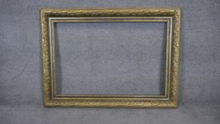 A gilt wood and floral gesso decorated picture frame. H81 W110 (H.60 W.90 internal)