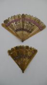 Two 19th century carved and pierced horn fans. One with hand painted floral decoration and the other