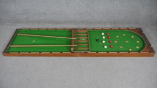 A 19th century table top billiards set in folding mahogany case with original balls and cues. (