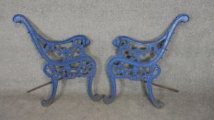 A pair of painted cast iron bench ends with lion mask arms. H.79cm