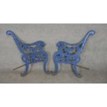 A pair of painted cast iron bench ends with lion mask arms. H.79cm