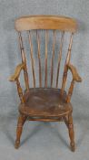 A 19th century beech stick back Windsor armchair with elm seat.