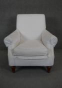 A 19th century style armchair in calico upholstery on fluted shaped supports. Seat height 47cm.